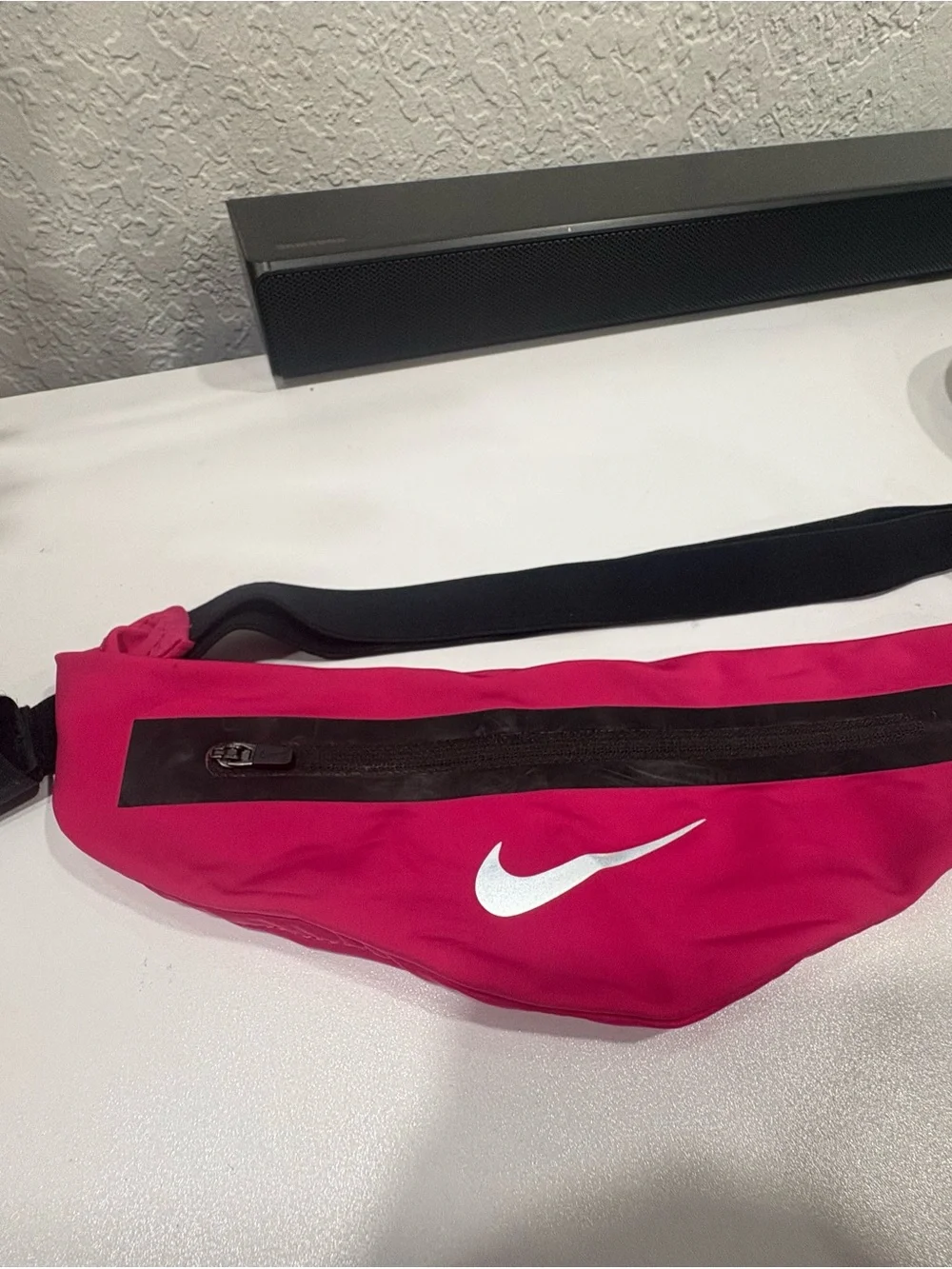 Nike pink waist pack with white Swoosh and black strap